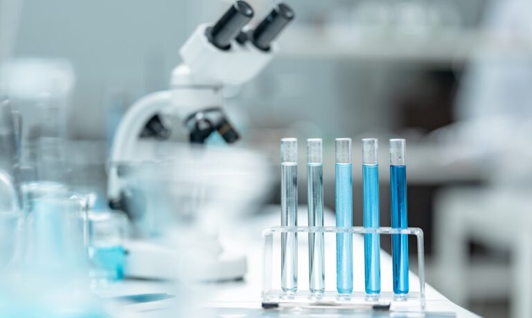 Chemical laboratory glassware with blue liquid samples in test tubes